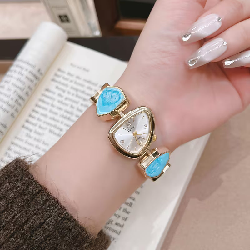 Gold watch with turquoise stone