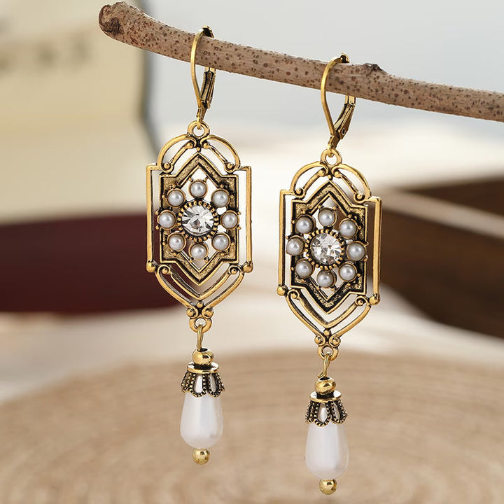 Vintage gold earrings with inset pearl