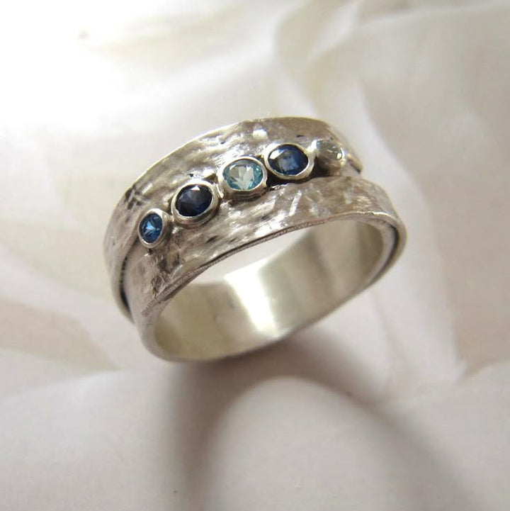 Silver ring with inlaid blue stones