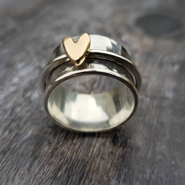 Silver ring with a golden heart