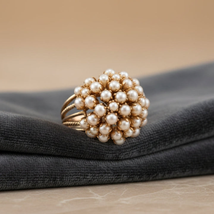 Classic gold ring with an inset pearl