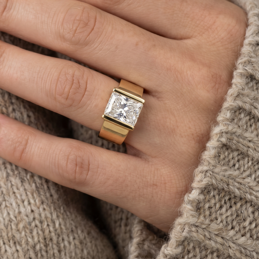 Princess-Cut Solitaire Ring with Bar-Tab Shoulders and Wide Gold-Tone Band