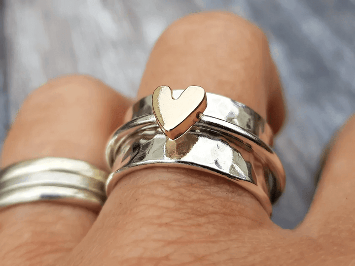 Silver ring with a golden heart