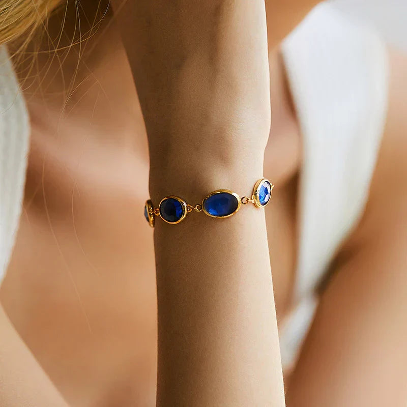 Charming gold bracelet with a blue stone
