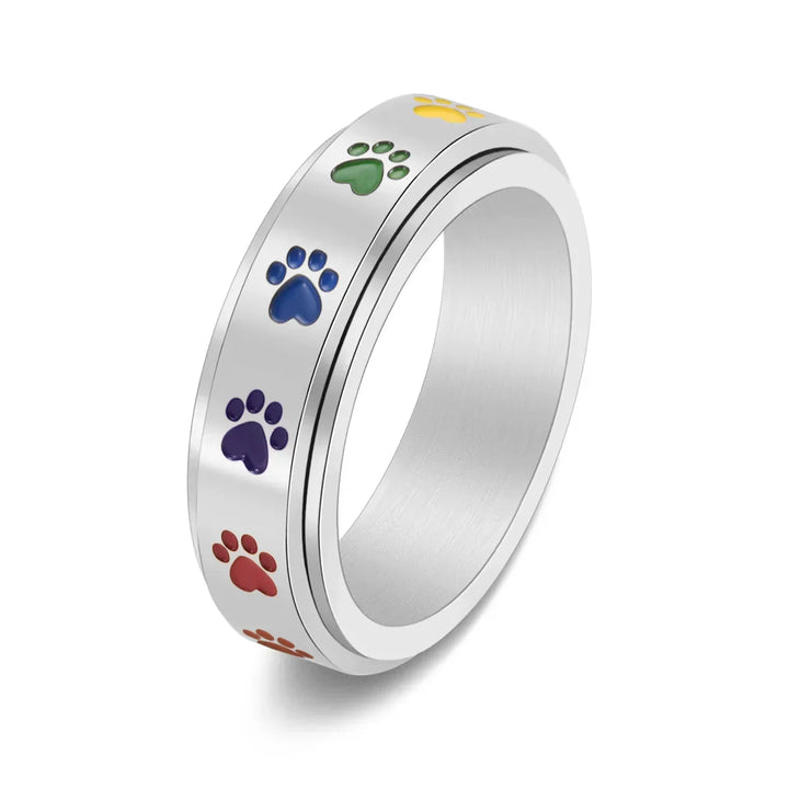 Rotating stress-reducing paw ring - stainless steel with rainbow paws