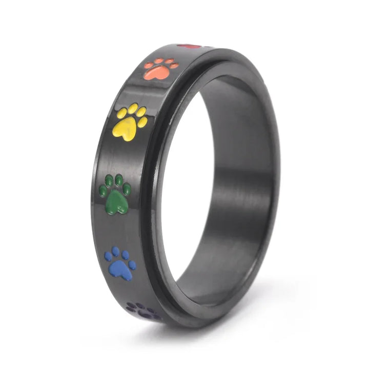 Rotating stress-reducing paw ring - stainless steel with rainbow paws