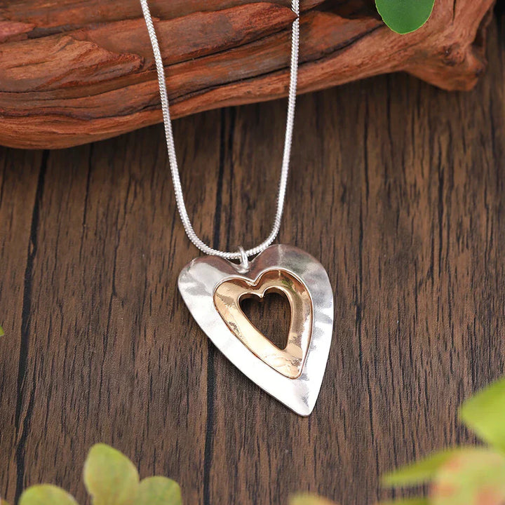 Vintage necklace with heart pendant in silver and gold