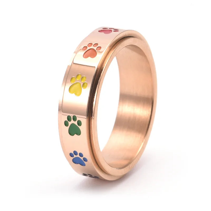Rotating stress-reducing paw ring - stainless steel with rainbow paws