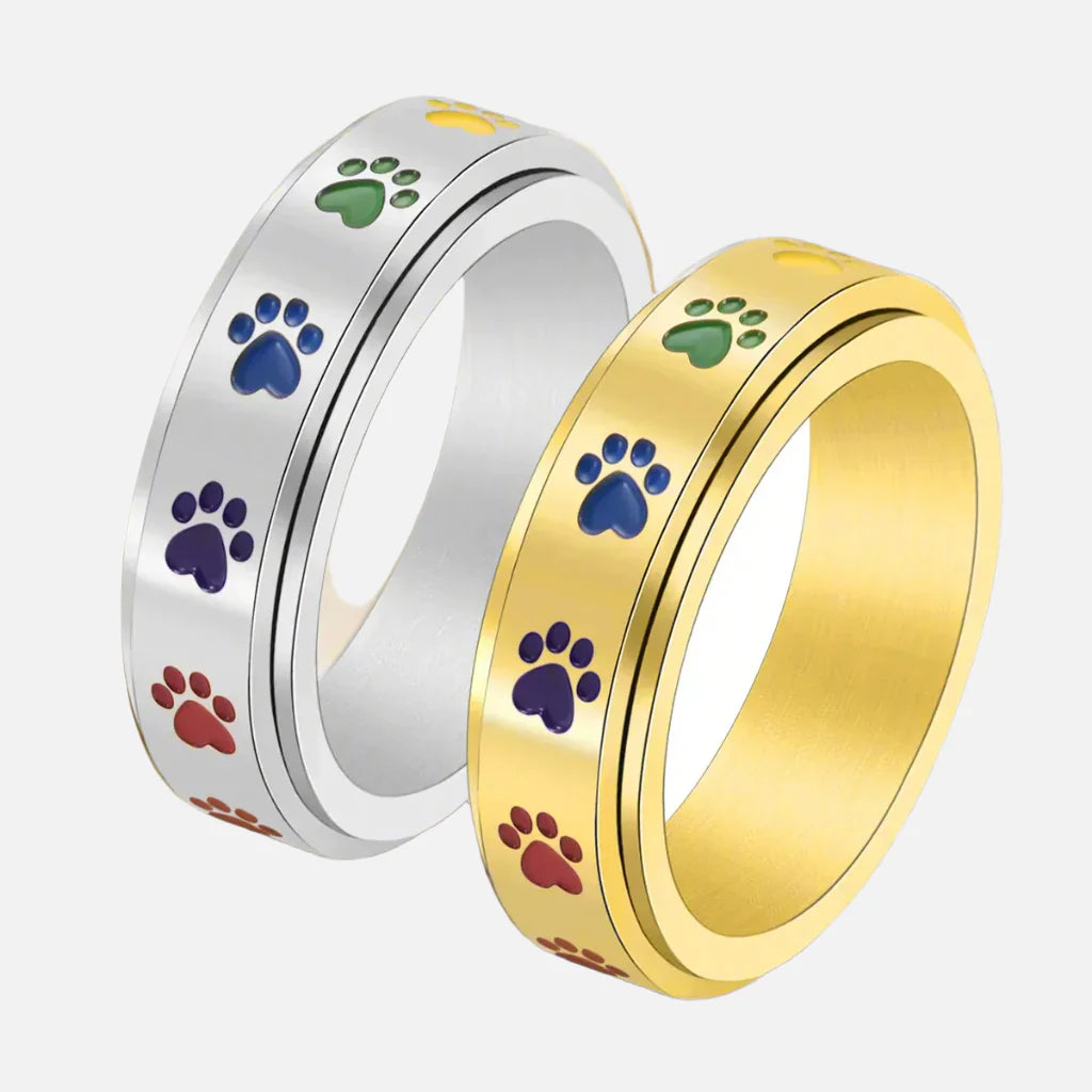 Rotating stress-reducing paw ring - stainless steel with rainbow paws