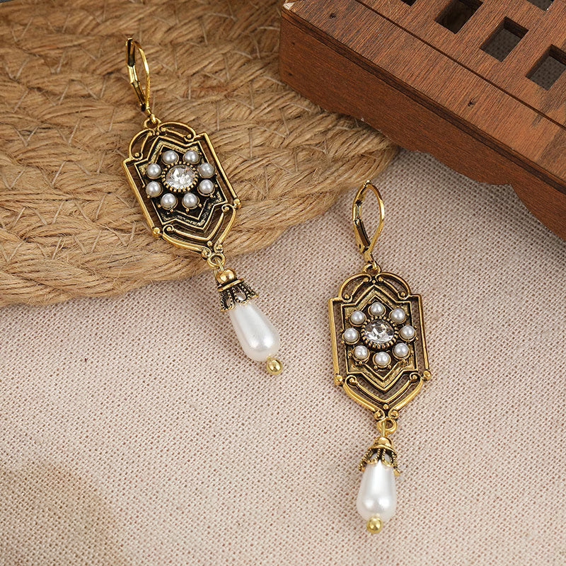 Vintage gold earrings with inset pearl