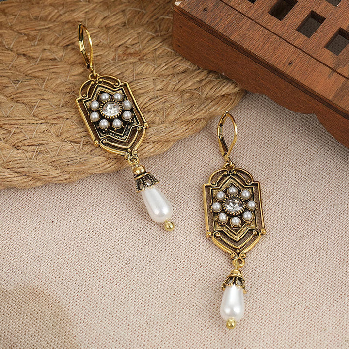 Vintage gold earrings with inset pearl