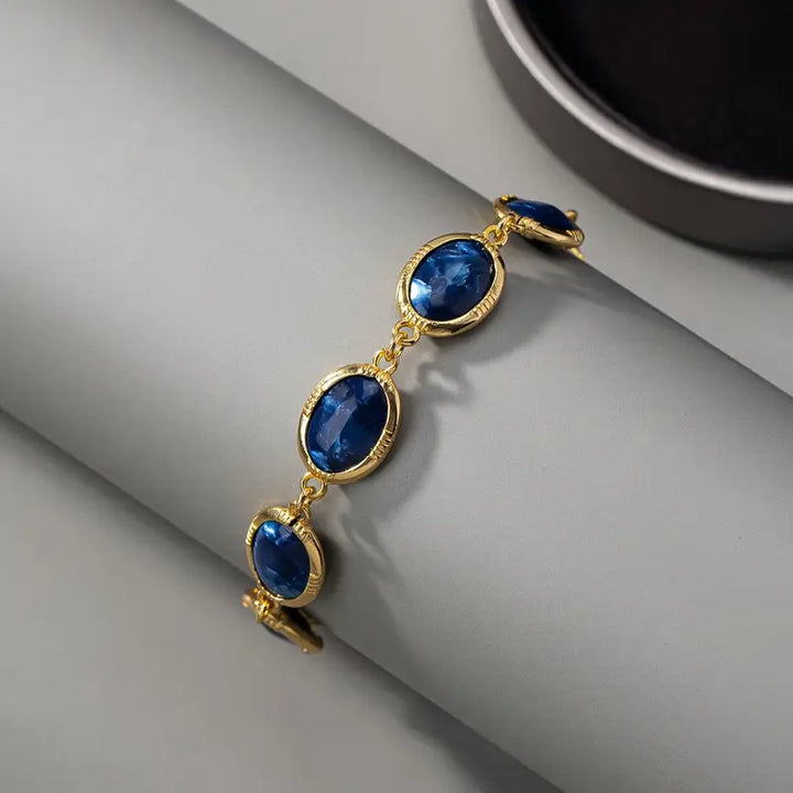 Charming gold bracelet with a blue stone