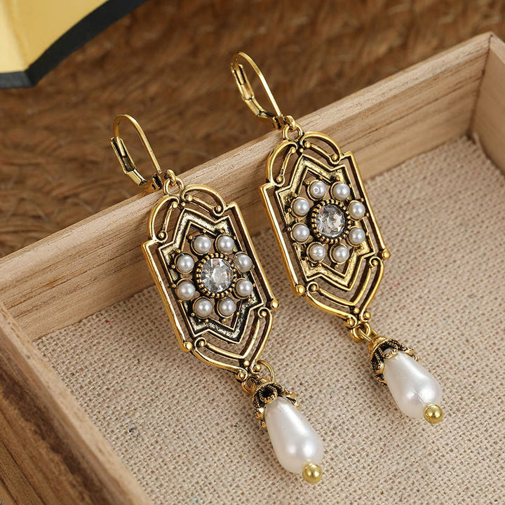 Vintage gold earrings with inset pearl