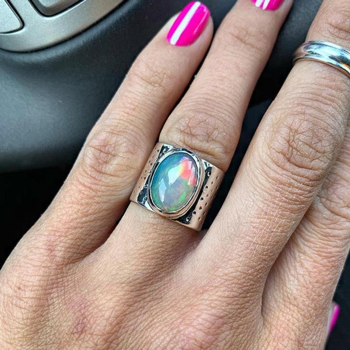 Ring with an oval shimmering stone