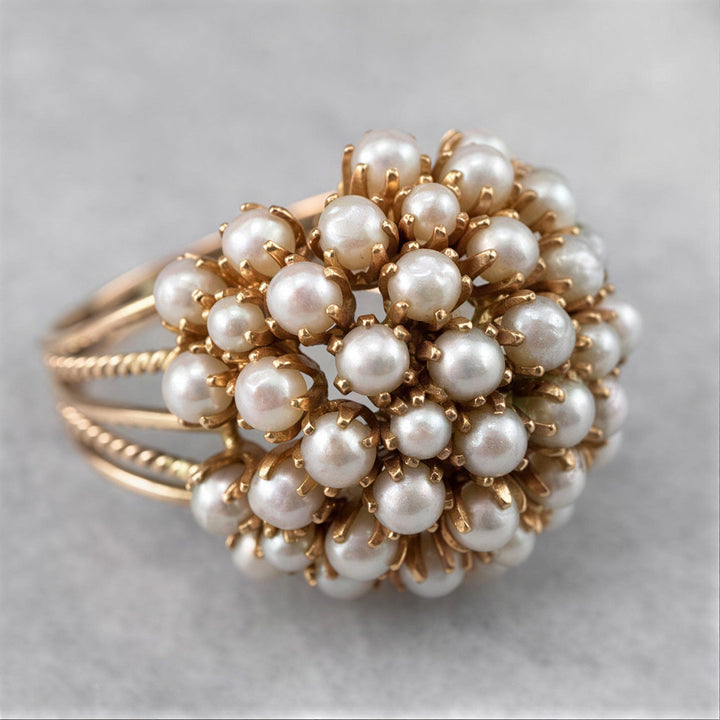 Classic gold ring with an inset pearl
