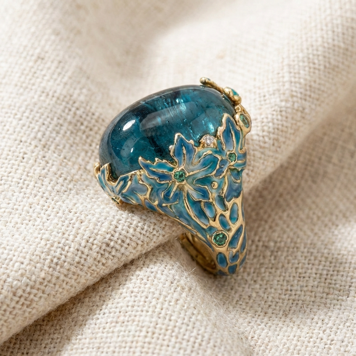 Elegant gold floral ring with a blue stone