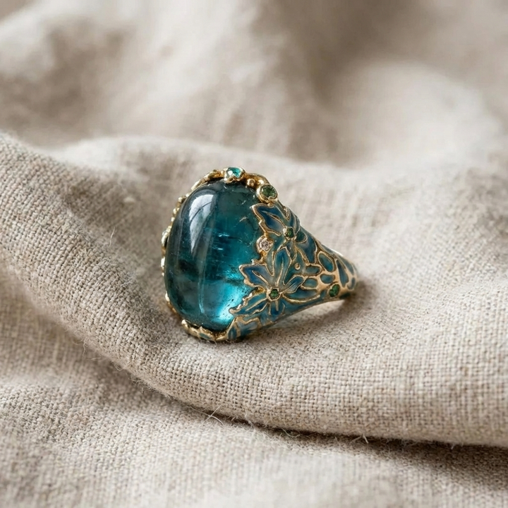Elegant gold floral ring with a blue stone