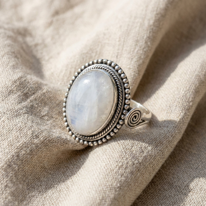 Ring with oval white gemstone