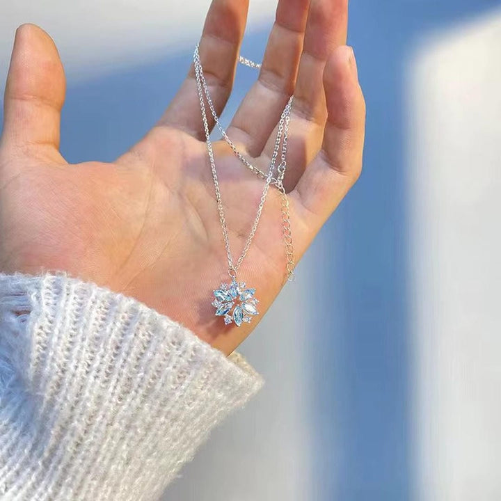 White gold floral pendant necklace with blue snowflake