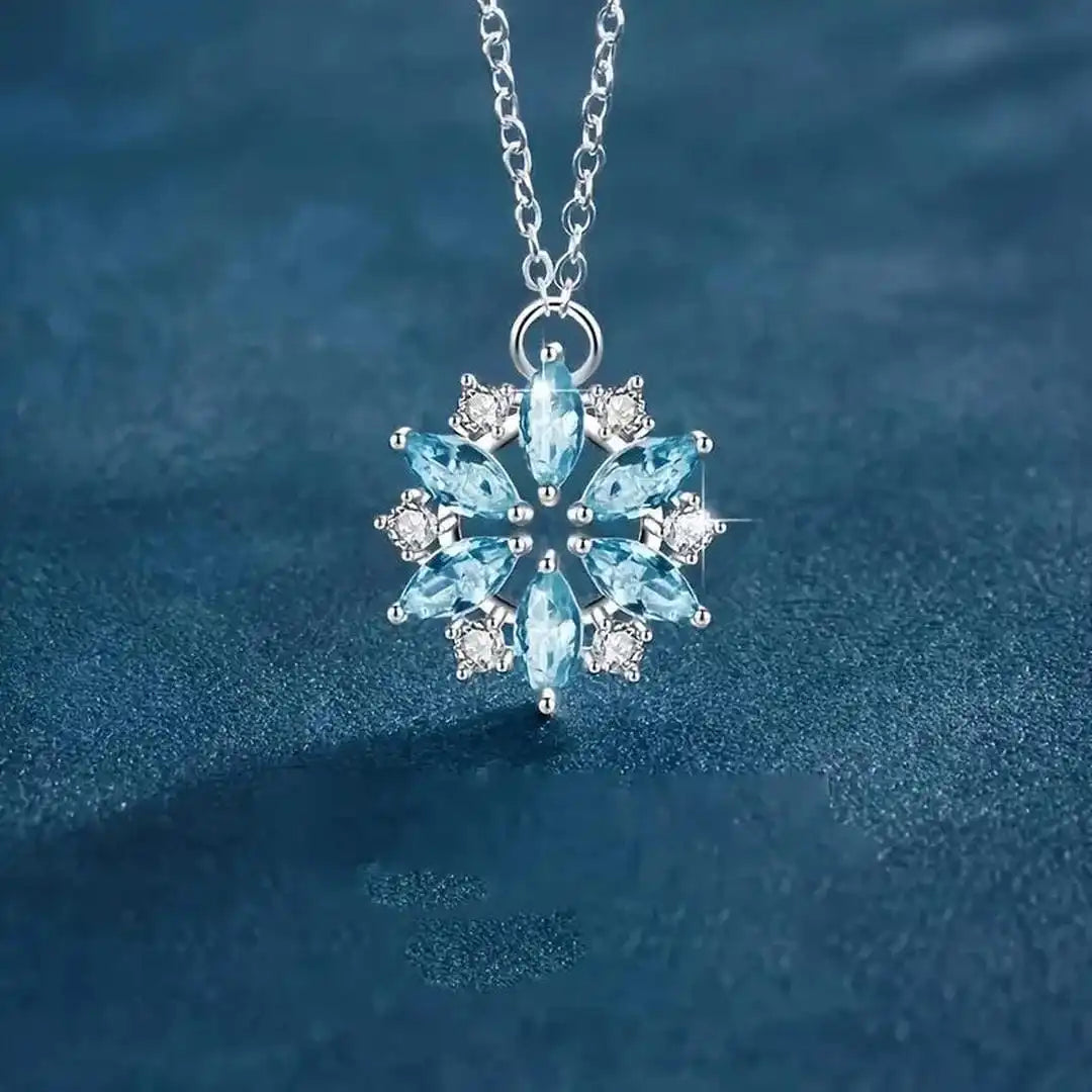 White gold floral pendant necklace with blue snowflake