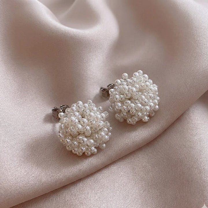 Classic earrings with an inset pearl